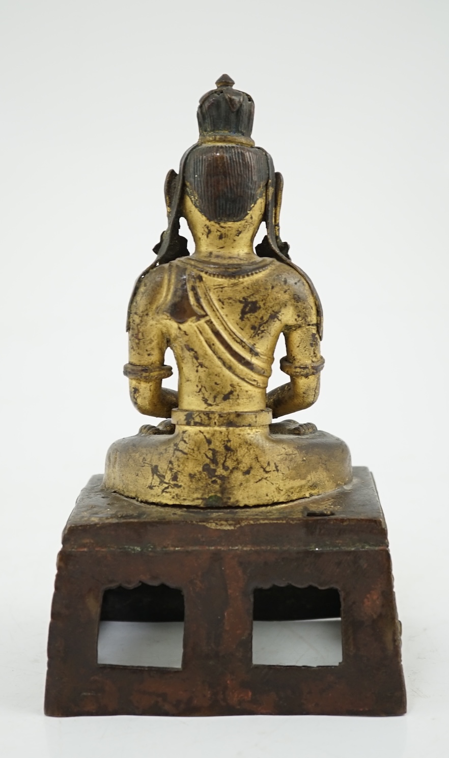 A Sino-Tibetan gilt repoussé copper alloy seated figure of Amitayus, Qianlong period, lacking aureole